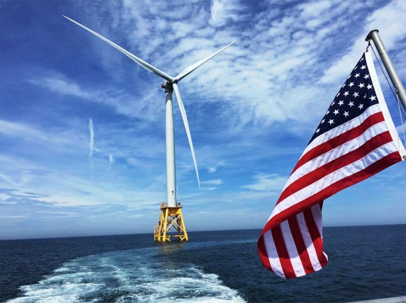 A photo of the Block Island Wind Farm's turbine with a US flag visible on the right